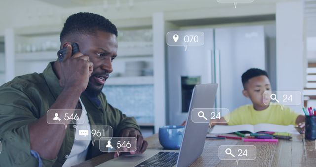 Father working at home on laptop, engaged in a phone call, while son studies next to him at the kitchen table. Overlay of social media interaction icons conveys digital connectivity and multitasking. Perfect for illustrating home office environment, work-life balance, modern parenting, and the integration of digital media in everyday life.