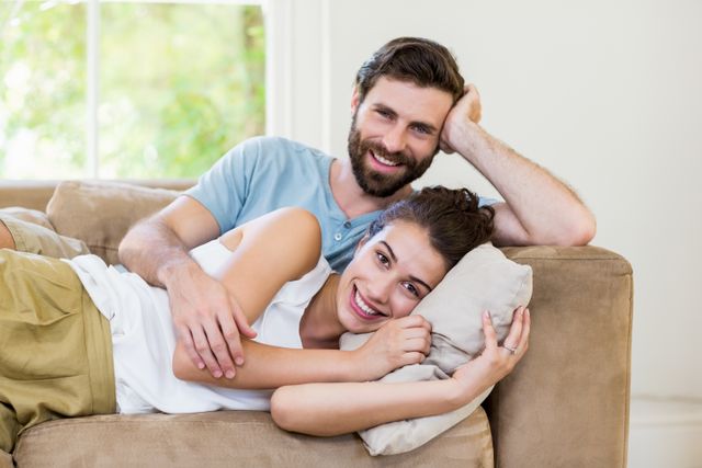 Portrait of young couple relaxing on sofa at home