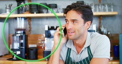 Barista Talking on Smartphone in Modern Coffee Shop