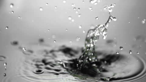 Lime Splashing Into Water in Mid-Air with Droplets