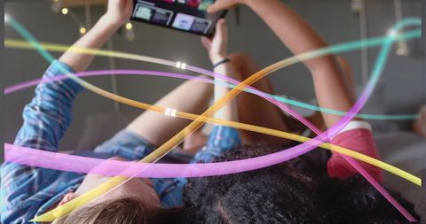 Young Adults Experiencing Digital Play with Colorful Neon Lights