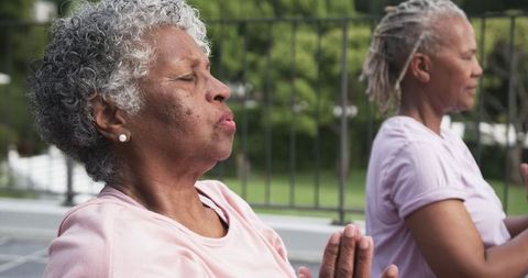 Senior Women Meditating and Practicing Yoga on Balcony