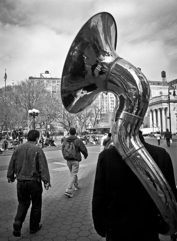 Street Scene with Tuba Performer in Urban Park