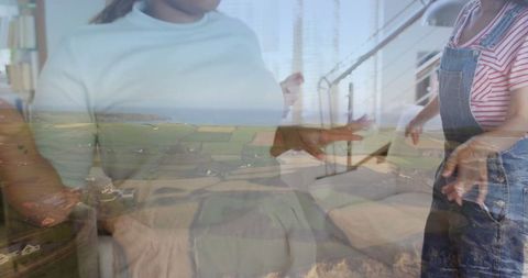 Women Chatting with Laptop on Bed and Overlapped Coastal Farmland
