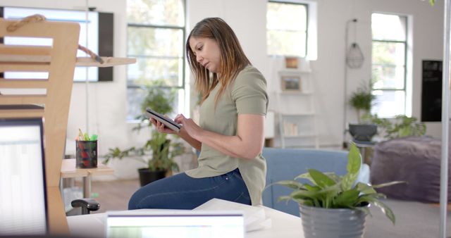 Focused Woman Working on Digital Tablet in Modern Office - Download Free Stock Images Pikwizard.com