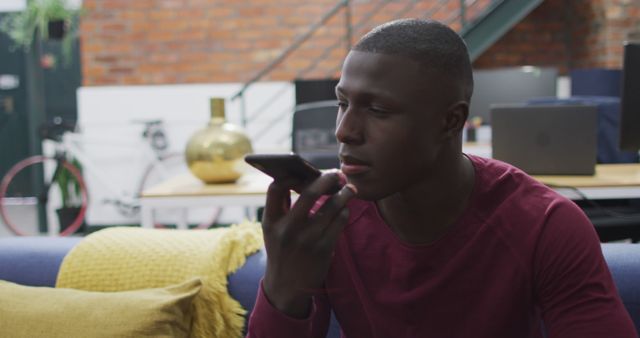 Young Man Using Smartphone Voice Command in Modern Living Room - Download Free Stock Images Pikwizard.com