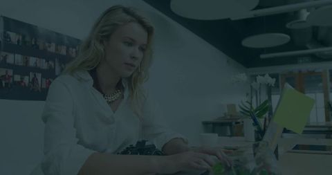 Woman Typing on Laptop in Modern Workspace