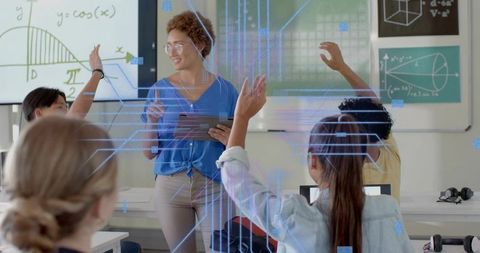 Female teacher teaching with tablet while students raise hands in AR classroom