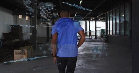 Man Analyzing Fitness Data with Smartwatch in Renovating Warehouse