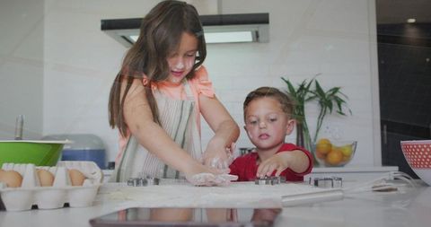 Siblings Baking Cookies Together in Bright Kitchen Floury Hands Using Cookie Cutters Family Fun