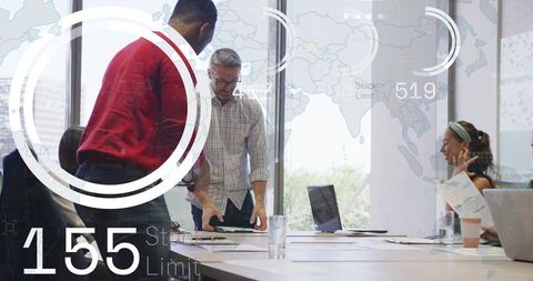 Business team collaborating and reviewing documents at conference table with HUD overlay