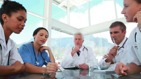 Medical Team Collaborating on Diagnosis in Bright Room