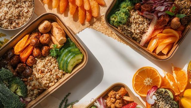 Meal-prep bowls featuring grains, roasted vegetables and citrus in compostable containers