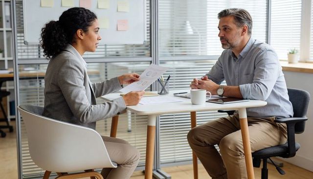 Hr representative presenting hiring data during one-on-one interview in modern office