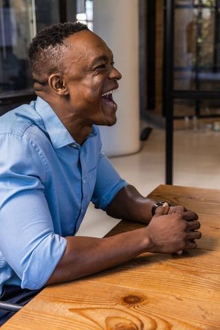 African american professional laughing during meeting in modern office