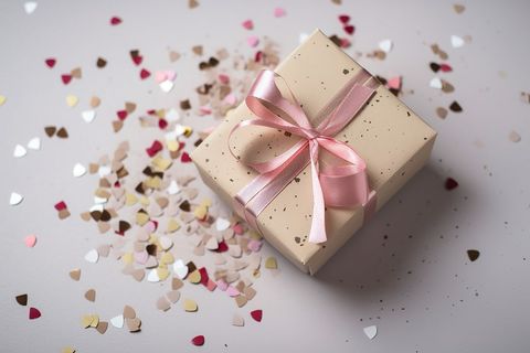 Gift Box with Pink Ribbon and Heart Confetti Celebration