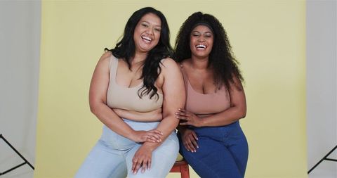 Diverse Female Friends Smiling in Casual Studio Photoshoot