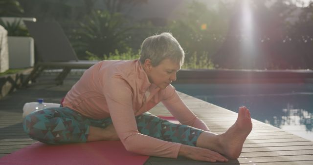 Senior Woman Practicing Yoga by Pool in Early Morning Light - Download Free Stock Images Pikwizard.com