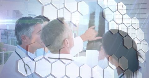 Diverse Doctors Analyzing X-Ray Amid Futuristic Hexagon Overlay