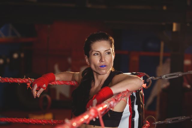 Thoughtful female boxer sitting in the ring - Download Free Stock Photos Pikwizard.com