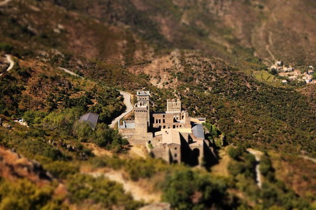 Castle presenting tilt-shift effect, enhancing a miniature-like appearance. Ideal for illustrating historical themes, travel blogs, educational materials about medieval architecture, and as background elements for fantasy settings.