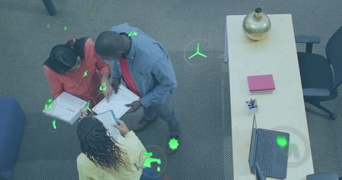 Colleagues Analyzing Data with Environmental Icon Overlay