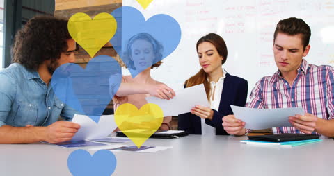 Colleagues Reviewing Documents with Colorful Animated Elements