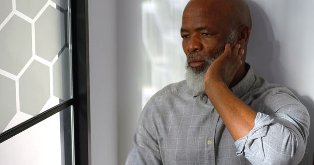 Senior Man Contemplating by Window in Casual Outfit - Download Free Stock Images Pikwizard.com