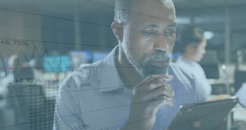 Business Executive Analyzing Data on Tablet