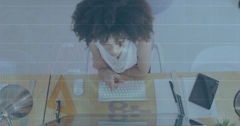 Businesswoman Analyzing Financial Data with Graphs Overlay