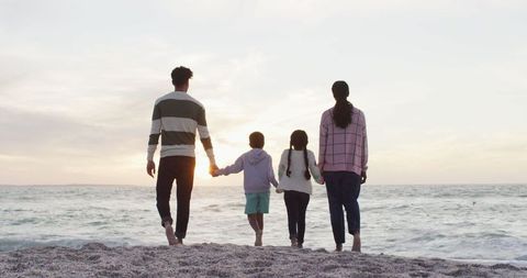 Family Walking on Beach at Sunset, Enjoying Quality Time
