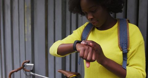Young Woman Using Smartwatch in City Street