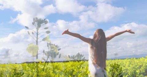 Woman embracing nature in flower meadow