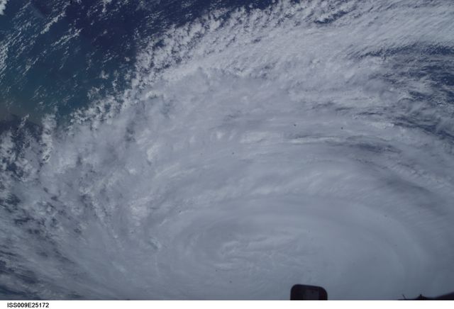 This image shows Hurricane Jeanne captured from the International Space Station on September 26, 2004. The swirling mass of clouds demonstrates the immense power and scale of the hurricane as it moves across the ocean. This image can be used for articles and projects related to meteorology, climate change, Earth observation, space exploration, or disaster preparedness and responses.