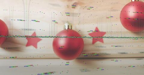 Glitched red christmas bauble hanging over rustic wood with digital distortion