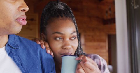 Affectionate Couple Enjoying Coffee in Cozy Log Cabin