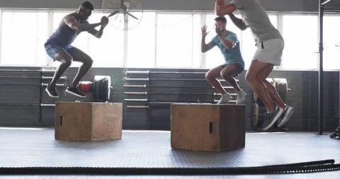 men performing box jumps in gym for fitness and agility - Download Free Stock Images Pikwizard.com