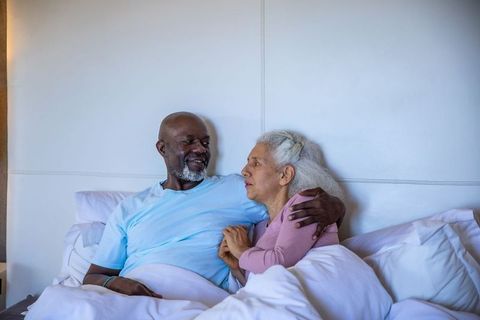 Senior Couple Sharing Intimate Moment on Cozy Bed