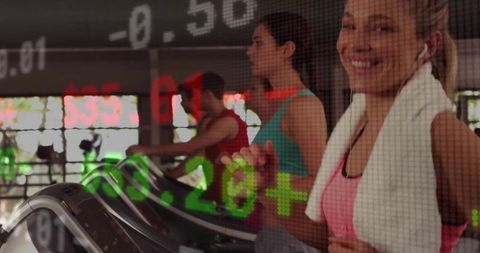 Women Exercising on Treadmills with Fitness Data Overlay