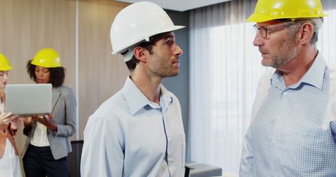 Engineers Discussing Project in Modern Office Setting - Download Free Stock Images Pikwizard.com