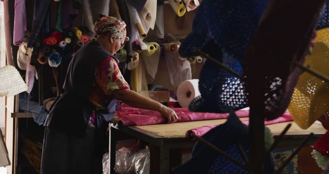 Seamstress working in fabric shop with colorful textiles - Download Free Stock Images Pikwizard.com