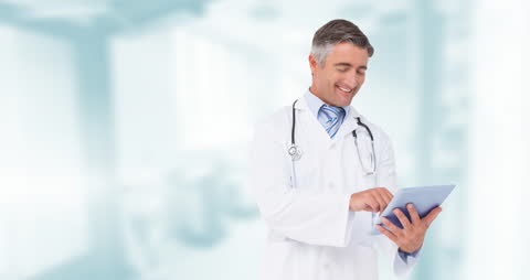 Caucasian Doctor Smiling While Using Digital Tablet in Hospital