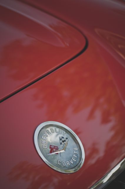 Classic Chevrolet Corvette Emblem on Red Vintage Car Hood - Download Free Stock Photos Pikwizard.com