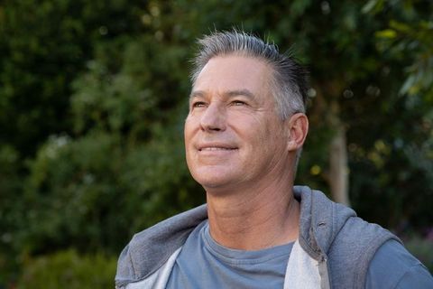Mature Man Enjoying Tranquility in Lush Green Park Environment