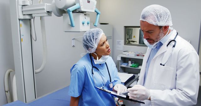 Medical Team Discussing Patient Records in Hospital Radiology Room - Download Free Stock Images Pikwizard.com