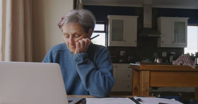 Elderly Woman at Home Working with Laptop and Documents - Download Free Stock Images Pikwizard.com