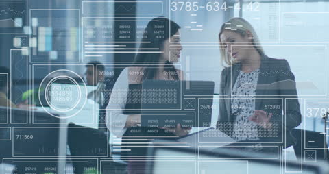 Female Colleagues Analyzing Data in Modern Office Setting