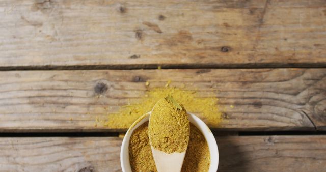 Wooden Spoon Filled with Ground Turmeric on Rustic Table - Download Free Stock Images Pikwizard.com