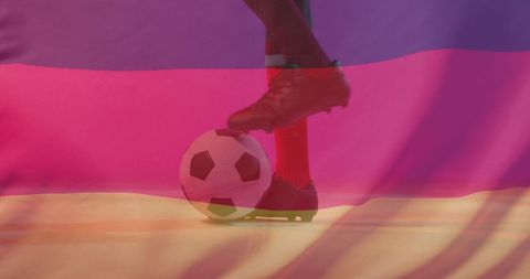 Soccer player kicking ball with german flag background