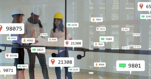 Team of Engineers Discuss Digital Blueprint with Floating Tech Graphics